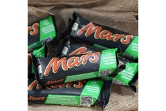 Image Pile of mars bars with paper wrappers.